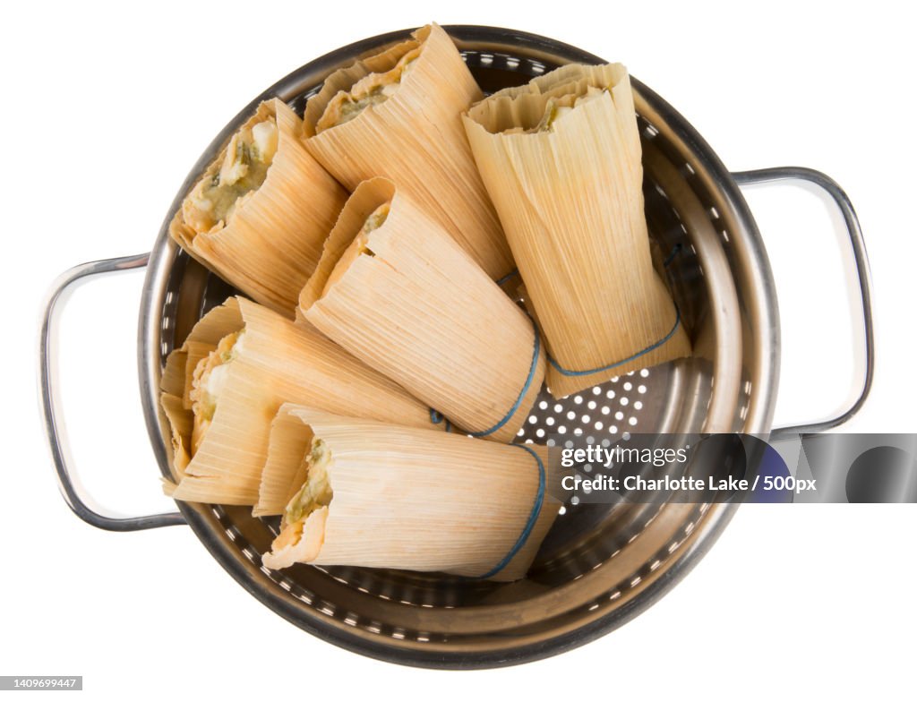 Directly above shot of raw pasta in bowl against white background