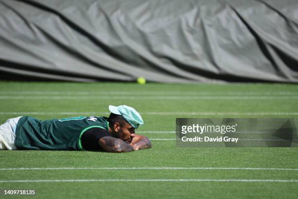 Nick Kyrgios of Australia rests during a practice session at the Aorangi Practice Courts during The Championships - Wimbledon 2022 at the All England...