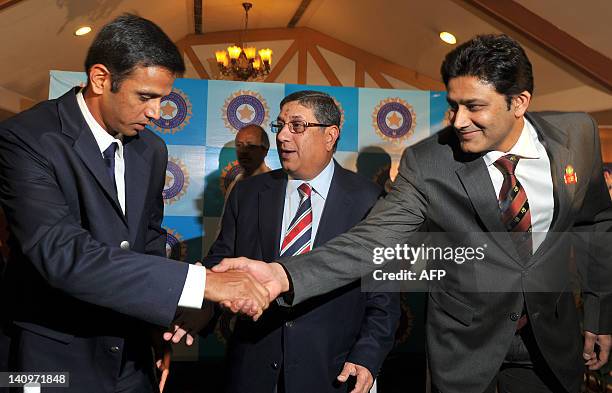 Indian cricketer Rahul Dravid shakes hands with former cricketer and cricket administrator Anil Kumble as Board of Control for Cricket in India...