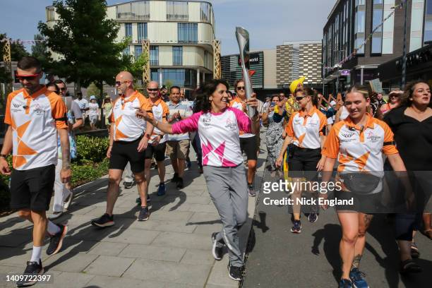 Batonbearer Julie Duhra holds the Queen's Baton during the Birmingham 2022 Queen's Baton Relay on July 19 Telford, United Kingdom.