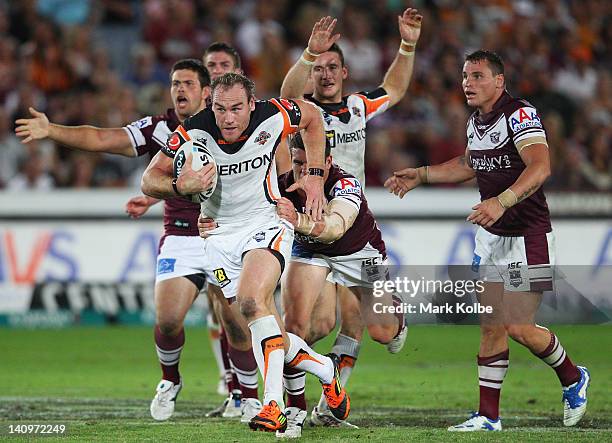 Gareth Ellis of the Tigers makes a break during the round two NRL match between the Manly Sea Eagles and the Wests Tigers at Bluetongue Stadium on...