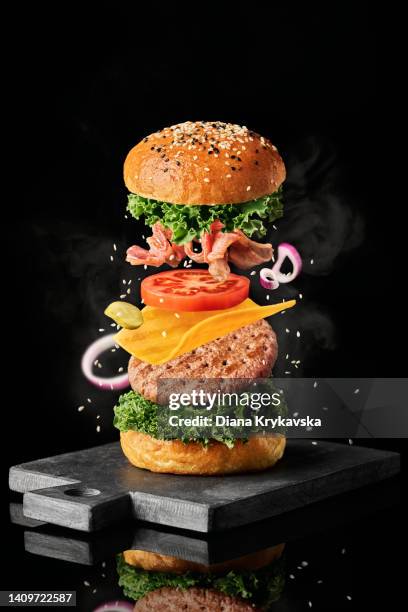 burger levitation on a black background - prague food stock pictures, royalty-free photos & images