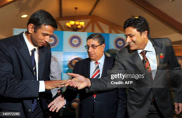 Indian cricketer Rahul Dravid shakes hands with former cricketer and cricket administrator Anil Kumble as Board of Control for Cricket in India...