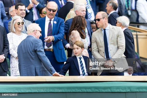 Prince William, Duke of Cambridge and his son Prince George talk with Rod Laver and Stan Smith in the royal box at the Mens Singles Final at The...