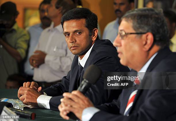 Indian cricketer Rahul Dravid looks on while Board of Control for Cricket in India President Narayanaswami Srinivasan talks to the media during a...