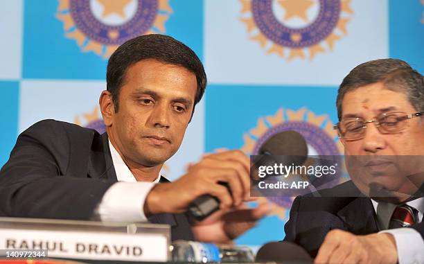 Indian cricketer Rahul Dravid hands over a microphone to Board of Control for Cricket in India President Narayanaswami Srinivasan during a press...