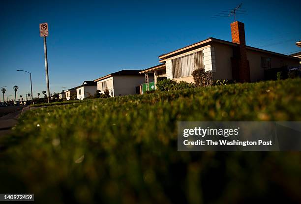 The rising sun lights up a houses on the 3800 block of South Norton Avenue, February 23 in the Leimert Park neighborhood of Los Angeles, California,...