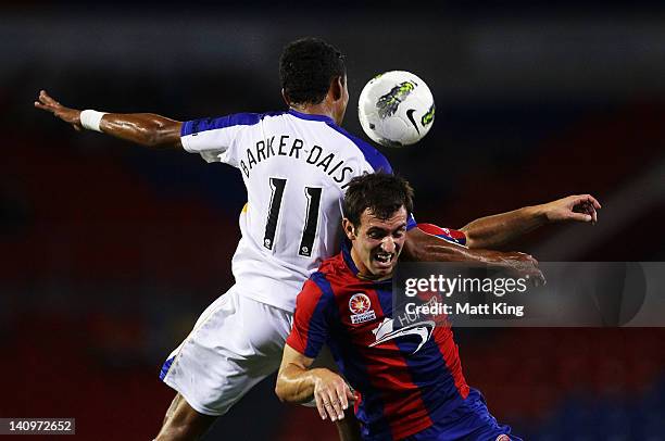 Francis Jeffers of the Jets and Jake Barker-Daish of United clash during the round 23 A-League match between the Newcastle Jets and Gold Coast United...