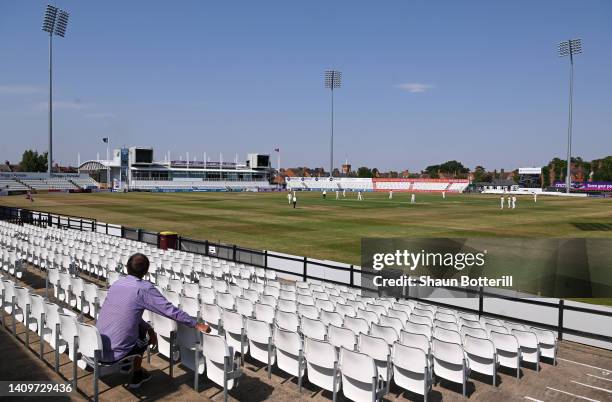 Spectator watches the shortened session due to the extreme heat during the LV= Insurance County Championship match between Northamptonshire and...