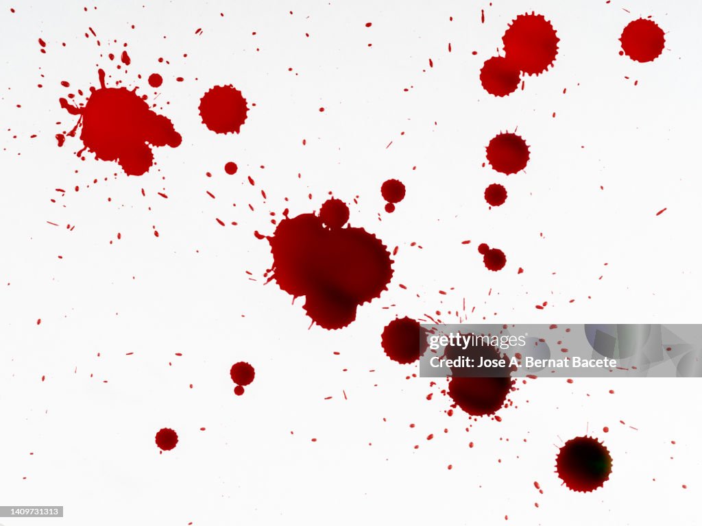 Drop of blood on slides on a white surface.