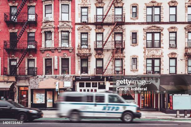 nypd police van moving through the streets of soho neighborhood in manhattan, new york. - soho new york stock pictures, royalty-free photos & images