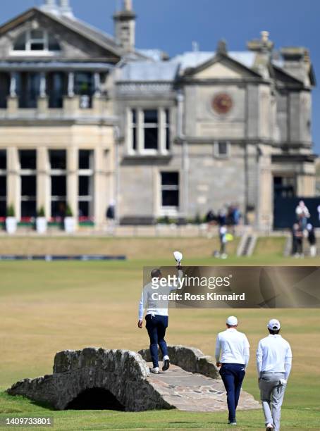 Tiger Woods of the United States acknowledges the crowd as he crosses the Swilcan Bridge during Day Two of The 150th Open at St Andrews Old Course on...