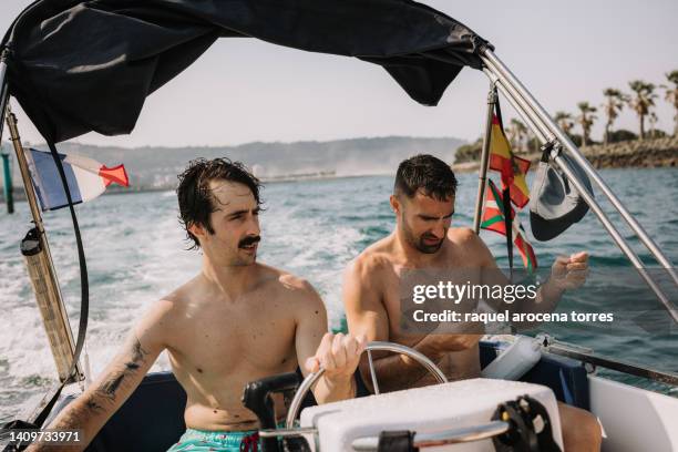 front view of two adult men sailing on a boat - hondarribia bildbanksfoton och bilder
