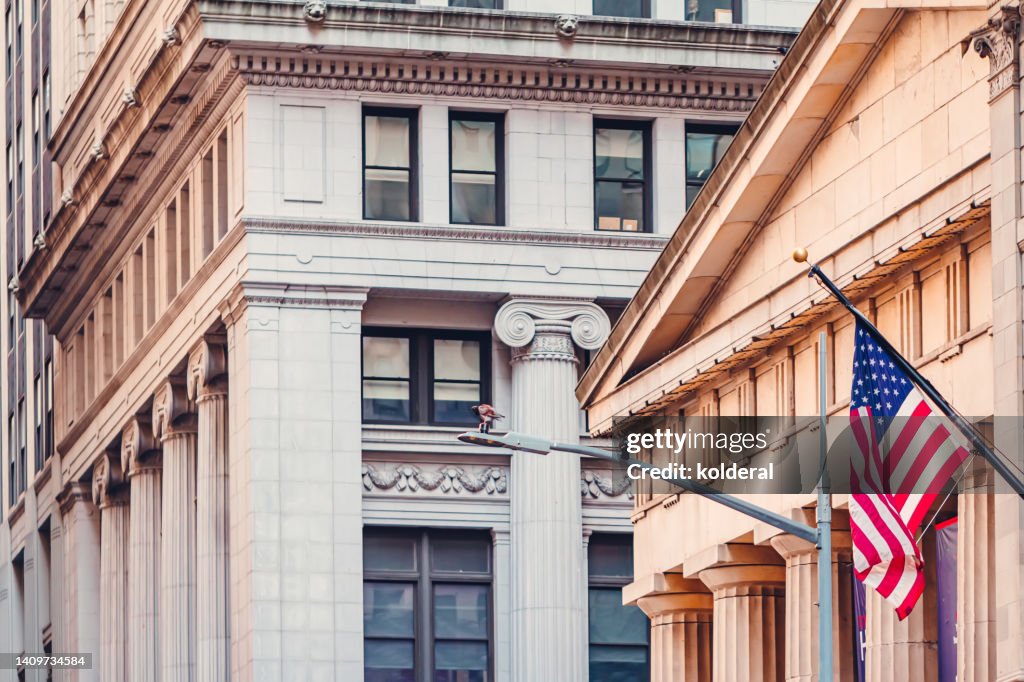 Neoclassical architecture of lower Manhattan, Wall Street buildings with American flag flying