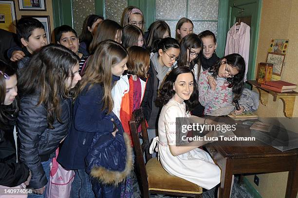 Children watch the wax figure of Anne Frank and their hideout reconstruction at Madame Tussauds on March 9, 2012 in Berlin, Germany.