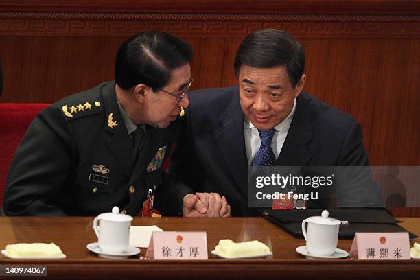 China's vice chairman of the Central Military Commission Xu Caihou talks shaking hands with Chongqing Municipality Communist Party Secretary Bo Xilai...