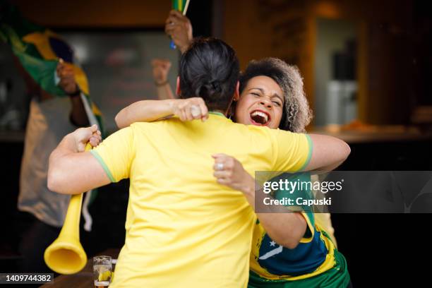 couple hugging each other after their team won a soccer match - fans embracing stock pictures, royalty-free photos & images