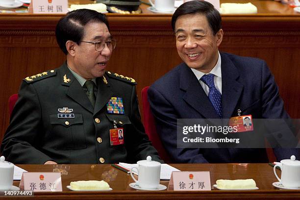 Xu Caihou, vice chairman of China's Central Military Commission, left, speaks with Bo Xilai, Chinese Communist Party secretary of Chongqing, at a...