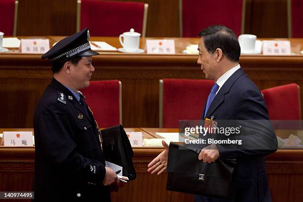 Bo Xilai, Chinese Communist Party secretary of Chongqing, right, reaches to shake hands with a delegate at a plenary session on the work report of...