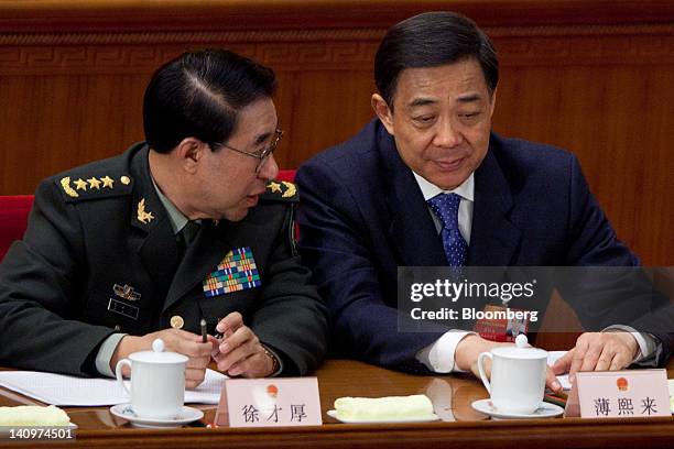 Xu Caihou, vice chairman of China's Central Military Commission, left, speaks with Bo Xilai, Chinese Communist Party secretary of Chongqing, at a...