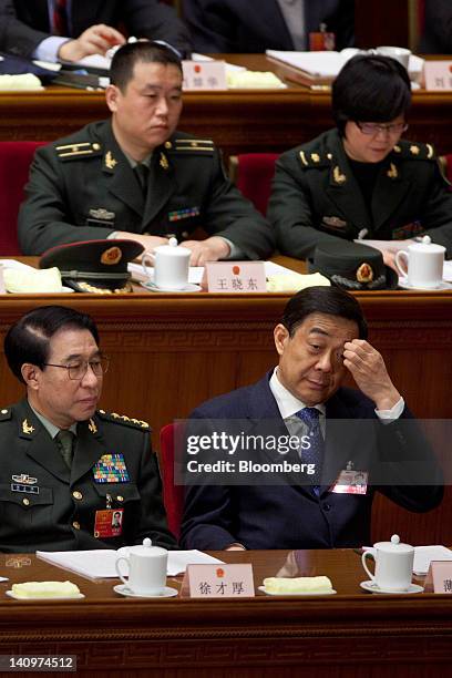 Bo Xilai, Chinese Communist Party secretary of Chongqing, bottom right, attends a plenary session on the work report of the National People's...