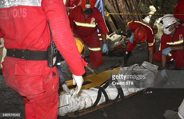 Rescue workers recover the body of one of the miners who died in the flood that ripped through inside a coal mine in the municipality of Angelopolis,...