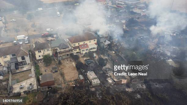 In this aerial view, smoke from fires in a residential area being fought by fire services are seen on July 19, 2022 in Wennington, England. A series...