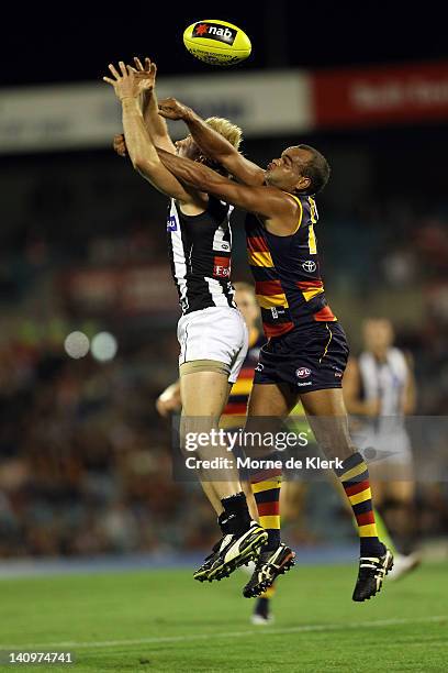 Graham Johncock of the Crows spoils a mark by Ben Sinclair of the Magpies during the round three NAB Cup match between the Adelaide Crows and the...