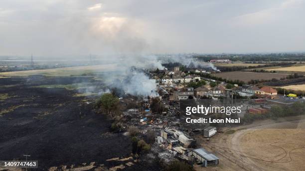 In this aerial view, smoke from fires in a residential area being fought by fire services are seen on July 19, 2022 in Wennington, England. A series...