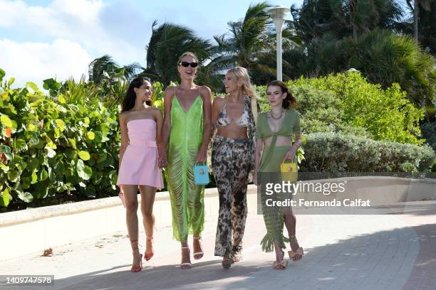Influencers Laura Arumugam, Victoria Jancke, Catwalk Chemist and Urszula Makowska holding bags by Bee2Bee Honey Bag during Miami Swim Week on July...