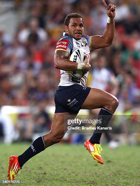 Matthew Bowen of the Cowboys celebrates as he scores the match winning try in the final seconds of the match during the round two NRL match between...