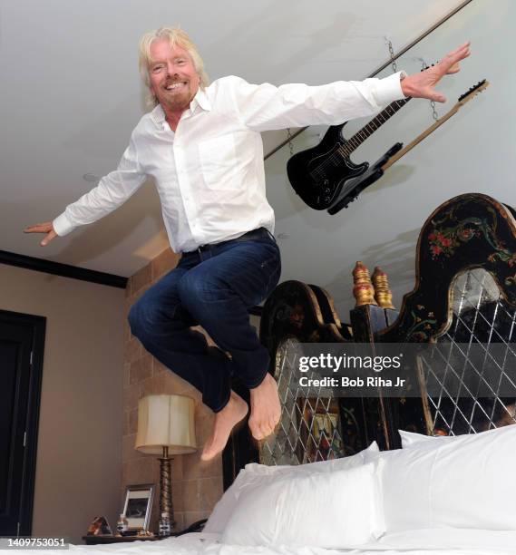 Sir Richard Branson jumps in bed, October 12, 2014 in Dallas, Texas.