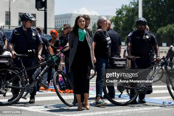 Rep. Alexandria Ocasio-Cortez is detained after participating in a sit in with activists from Center for Popular Democracy Action in front of the...