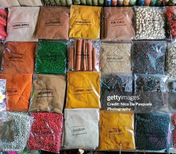 packets of colored spices at the local market, bali indonesia - bustina foto e immagini stock