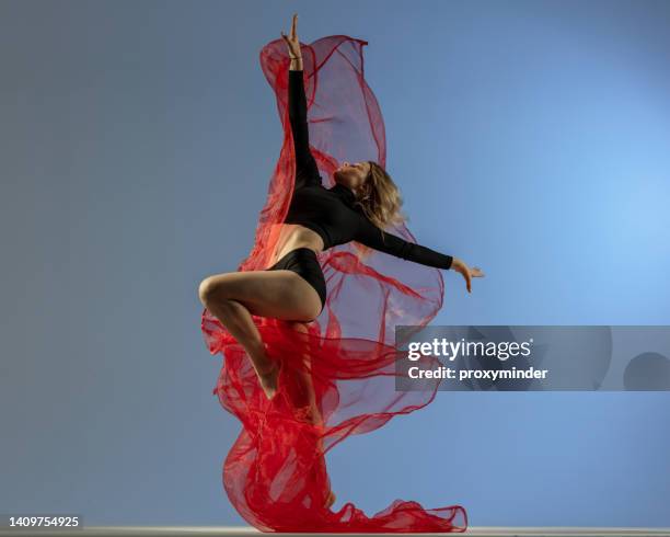 female dancer on blue background - dança moderna imagens e fotografias de stock