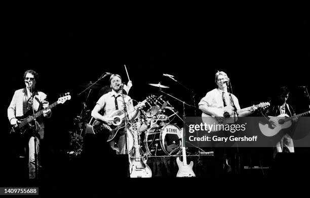 View of Pop musicians Dewey Bunnell , on acoustic guitar, and Gerry Beckley , on acoustic guitar, both of the group America, as they perform onstage...