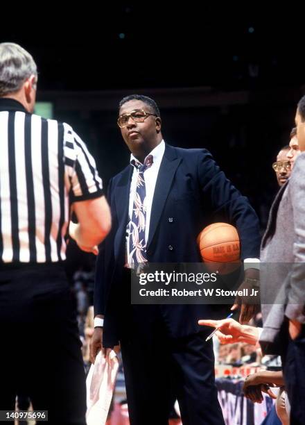 American baketball coach John Thompson of Georgetown University holds the ball as he speaks with a referee during a game against the University of...