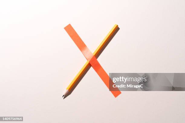 cross sign consists of a pencil covered with tape, censorship concept - censorship imagens e fotografias de stock