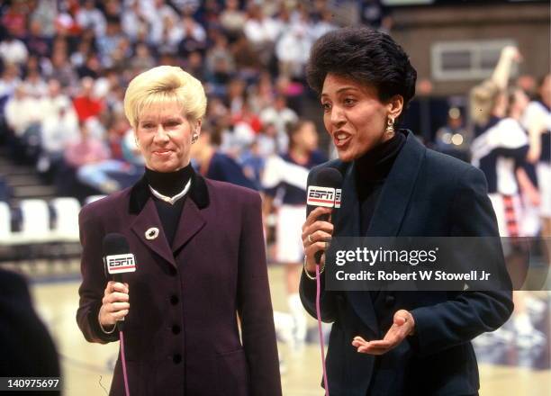 Television basketball commentators Mimi Griffin, left, and Robin Roberts, right, do pre-game analysis prior to a University of Connecticut women's...