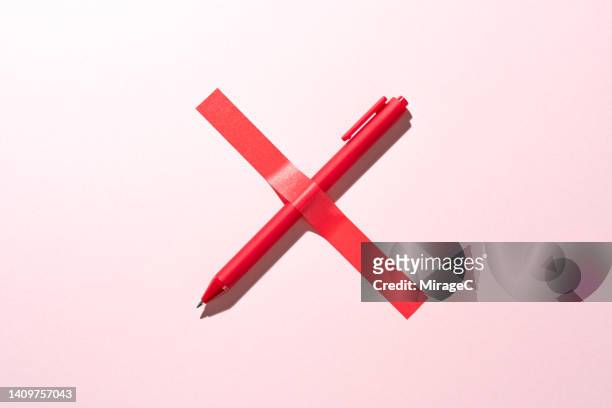 red cross sign consists of a pen covered with tape, censorship - exclusion concept stock pictures, royalty-free photos & images