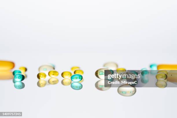 nutritional supplement soft capsules - antioxidant pill stock pictures, royalty-free photos & images