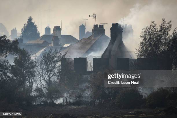 Smoke rising from fires being fought by fire services in a residential area is seen on July 19, 2022 in Wennington, England. A series of grass fires...