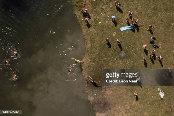 In this aerial view, people swim in the River Cam as the temperatures reach record levels on July 19, 2022 in Cambridge, England. Temperatures...