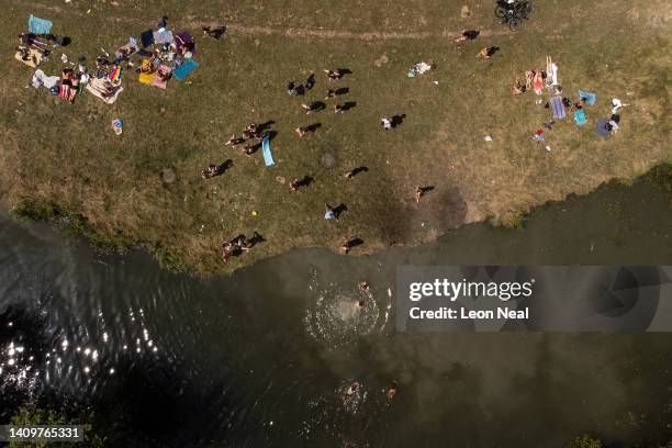 In this aerial view, people swim in the River Cam as the temperatures reach record levels on July 19, 2022 in Cambridge, England. Temperatures...