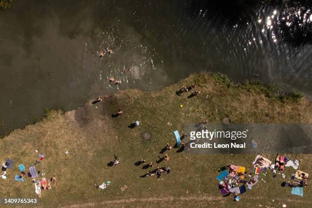 In this aerial view, people swim in the River Cam as the temperatures reach record levels on July 19, 2022 in Cambridge, England. Temperatures...