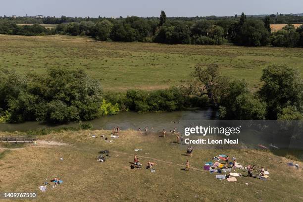 In this aerial view, people swim in the River Cam as the temperatures reach record levels on July 19, 2022 in Cambridge, England. Temperatures...