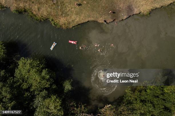 In this aerial view, people swim in the River Cam as the temperatures reach record levels on July 19, 2022 in Cambridge, England. Temperatures...