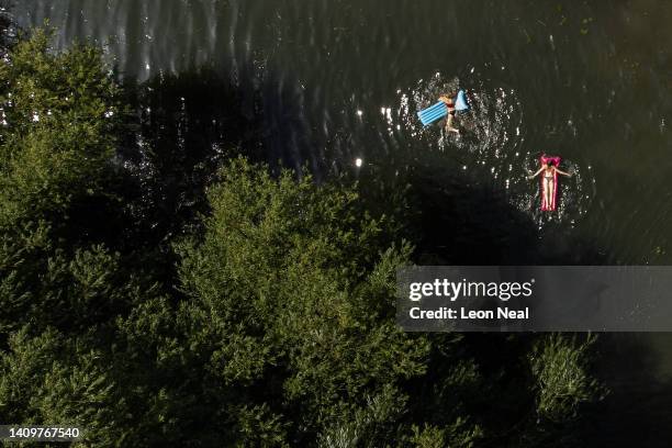 In this aerial view, people swim in the River Cam as the temperatures reach record levels on July 19, 2022 in Cambridge, England. Temperatures...