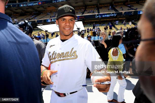 Juan Soto of the Washington Nationals signs an autograph prior to the 92nd MLB All-Star Game presented by Mastercard at Dodger Stadium on July 19,...