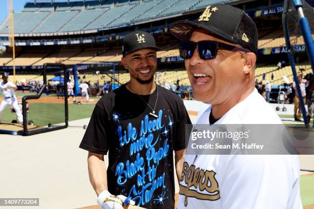 Mookie Betts of the Los Angeles Dodgers speaks with manager Dave Roberts during batting practice ahead of the 92nd MLB All-Star Game presented by...